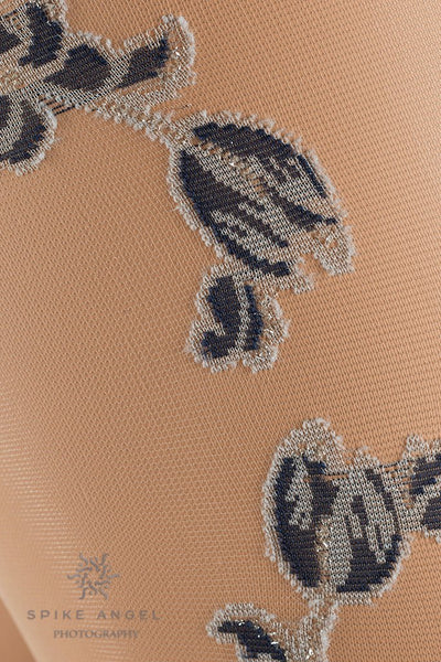 Enea Floral Shiny Hold Up Thigh Highs by Trasparenze feature a stunning floral design and a sleek, shiny finish.