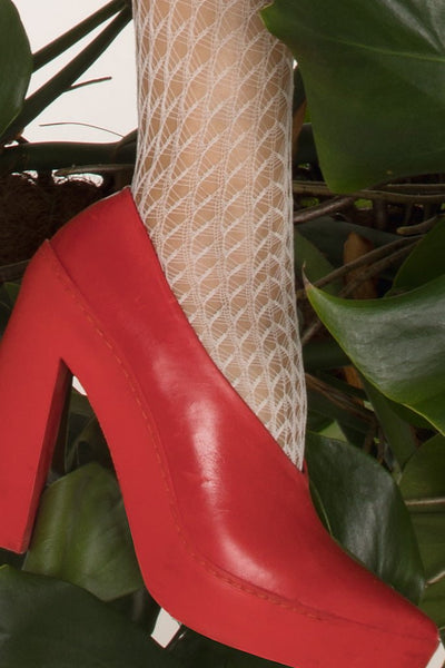 Stylish red heels paired with Muricata Geometric Fashion Tights for a chic, modern look from Trasparenze.